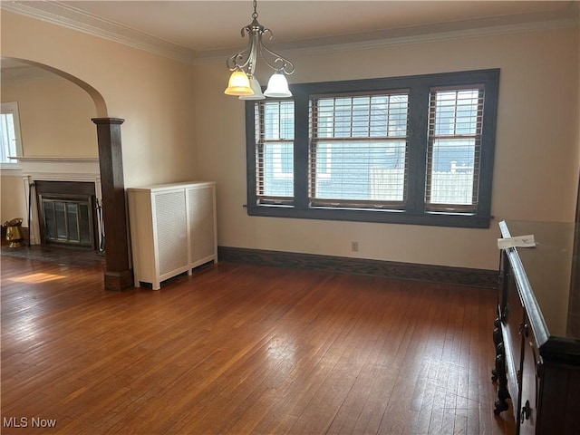 interior space featuring dark wood-type flooring, crown molding, and a wealth of natural light