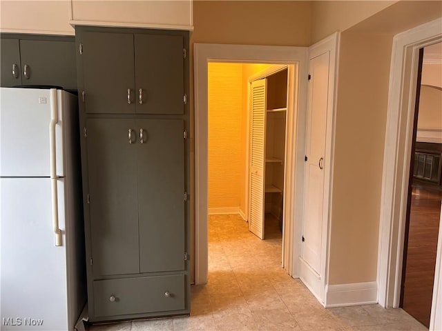 kitchen featuring gray cabinetry and freestanding refrigerator