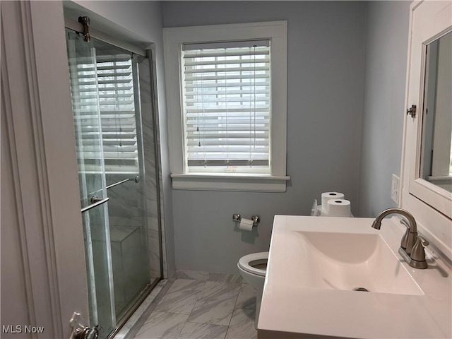 bathroom with toilet, marble finish floor, a shower stall, and a healthy amount of sunlight