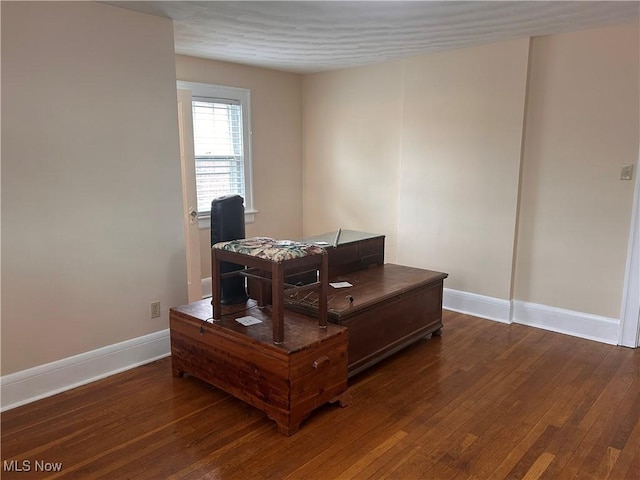 office area featuring baseboards and dark wood-style flooring