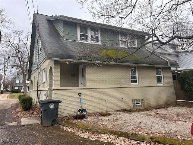 view of property exterior with brick siding