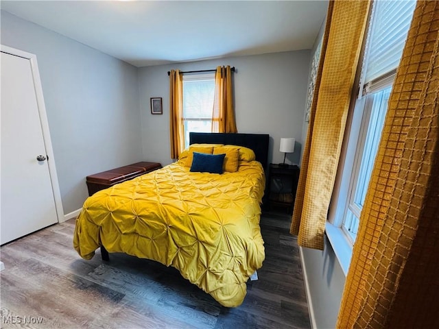 bedroom with baseboards and wood finished floors