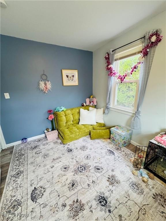 bedroom featuring baseboards and wood finished floors