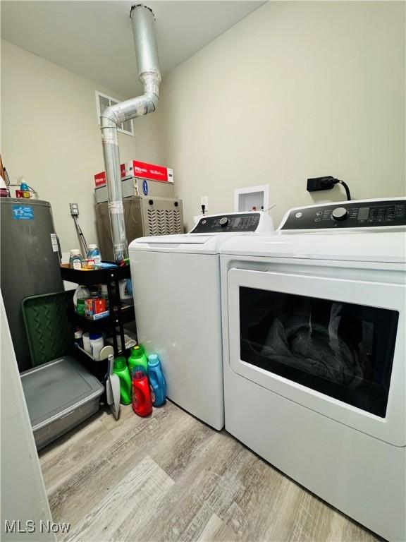 washroom featuring washer and clothes dryer, laundry area, and wood finished floors