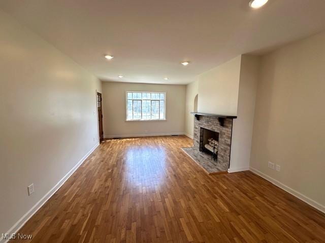 1119 Abbey Pl, Zanesville, OH 43701 - unfurnished living room featuring a fireplace, baseboards, and wood finished floors