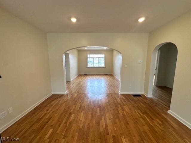 1119 Abbey Pl, Zanesville, OH 43701 - unfurnished room featuring baseboards, arched walkways, and wood finished floors