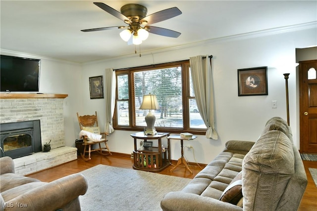 living room with wood finished floors, ceiling fan, and ornamental molding