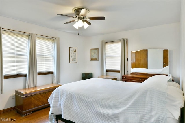 bedroom with wood finished floors and a ceiling fan