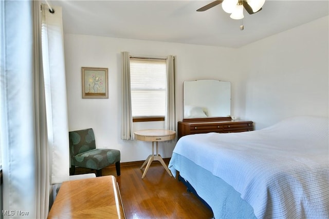 bedroom with wood finished floors and a ceiling fan