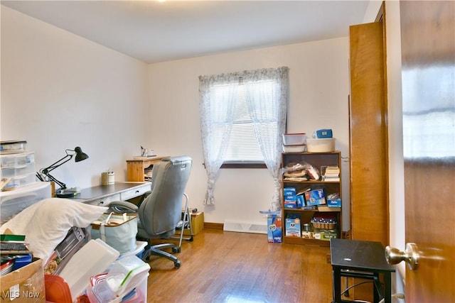 office space with wood finished floors and baseboards