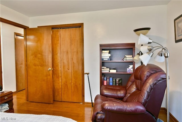 bedroom with baseboards and wood finished floors