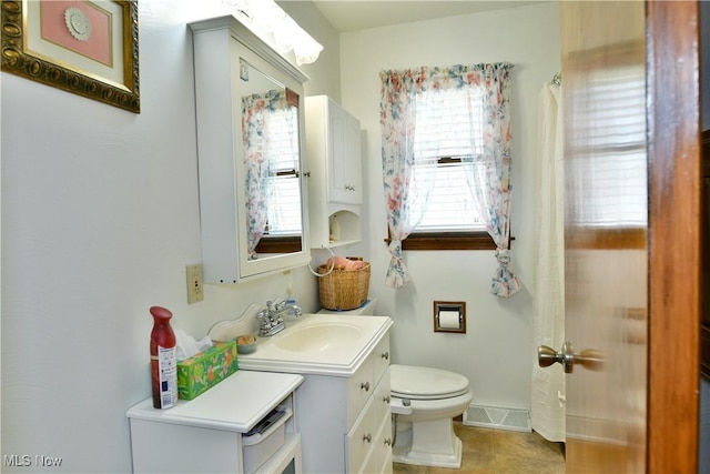 bathroom with vanity, toilet, visible vents, and tile patterned flooring