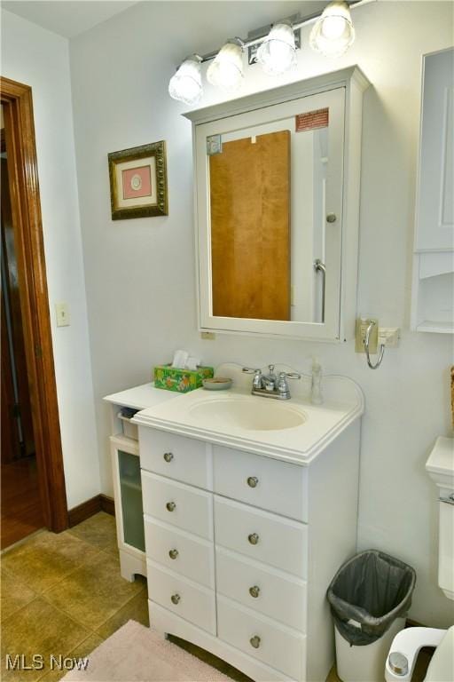 bathroom with tile patterned flooring, vanity, and baseboards