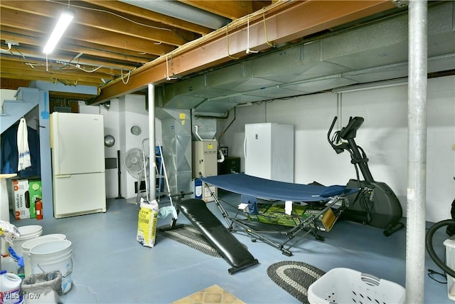 unfinished basement with freestanding refrigerator