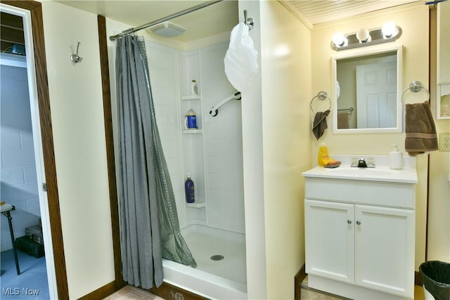 full bathroom featuring visible vents, a shower stall, and vanity