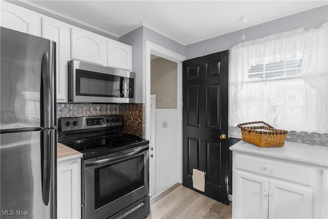 kitchen featuring light countertops, white cabinets, and appliances with stainless steel finishes