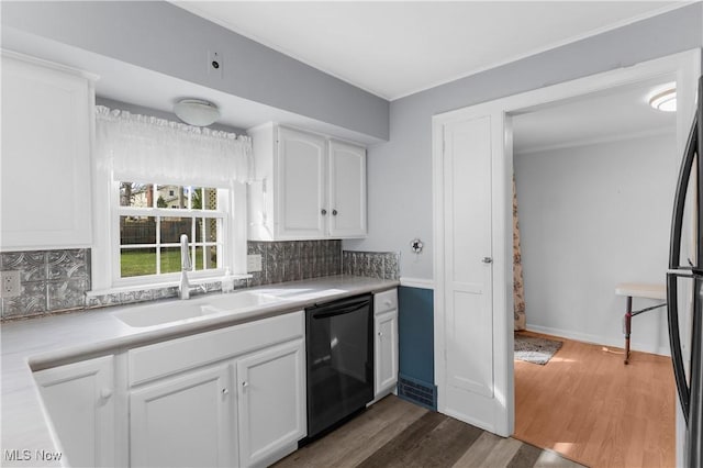 kitchen featuring backsplash, black appliances, dark wood-style floors, white cabinetry, and a sink