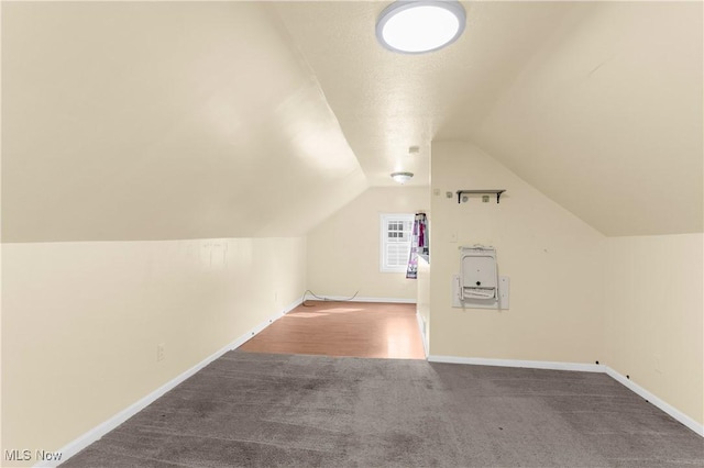 additional living space with lofted ceiling, carpet flooring, and baseboards