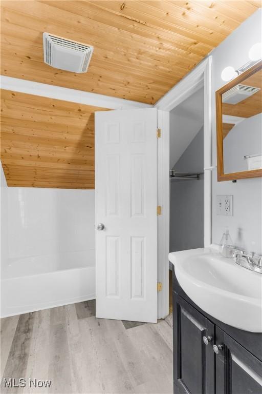 bathroom featuring visible vents, wood finished floors, wooden ceiling, and vanity