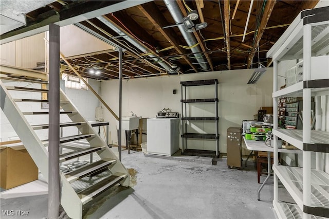 unfinished below grade area featuring stairway and washer / clothes dryer