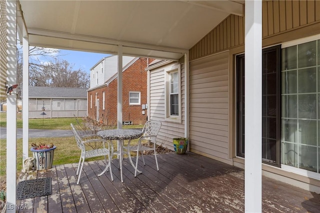 deck with outdoor dining area and fence