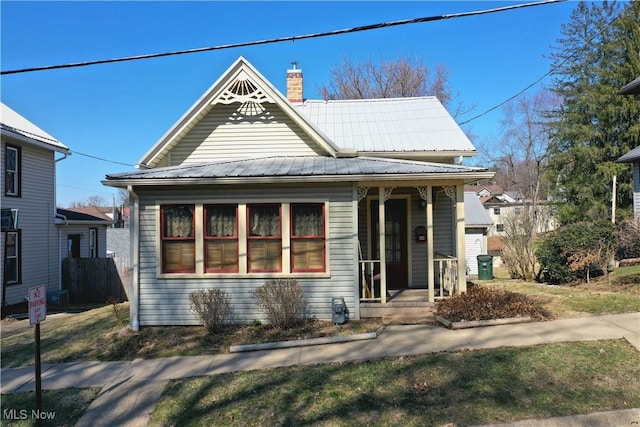 view of front of home featuring a chimney and metal roof