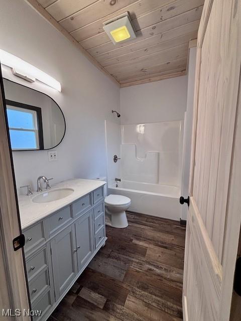 full bath with toilet, wood finished floors, vanity, wood ceiling, and shower / bathtub combination