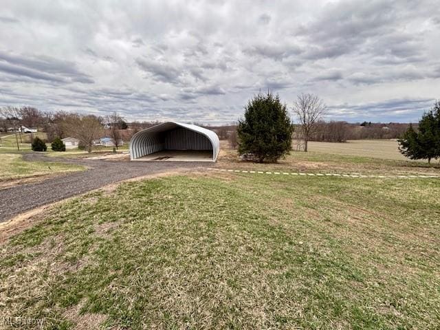 view of yard featuring a carport and driveway