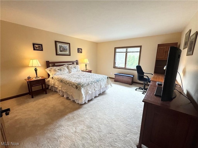 bedroom featuring baseboards and light colored carpet