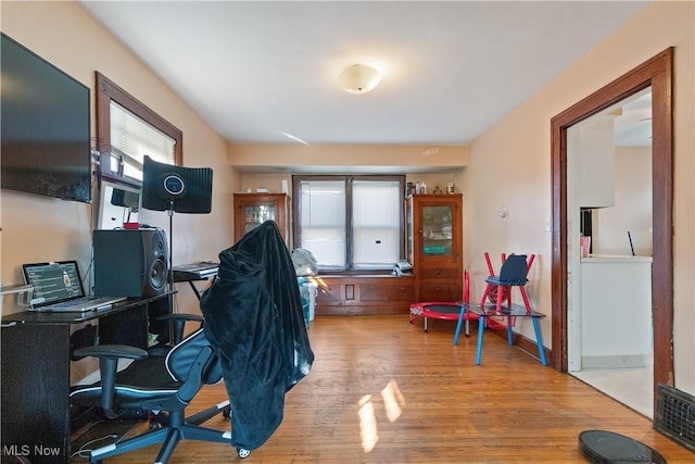 office space with baseboards and wood finished floors