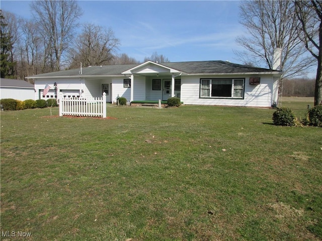 ranch-style house featuring a garage and a front lawn