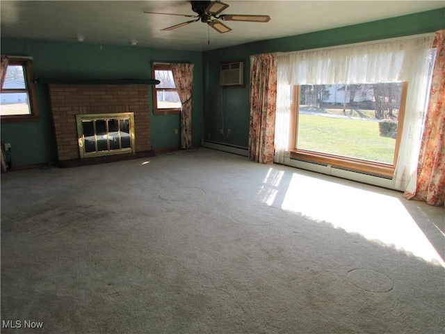 unfurnished living room featuring a fireplace, an AC wall unit, a baseboard heating unit, and ceiling fan