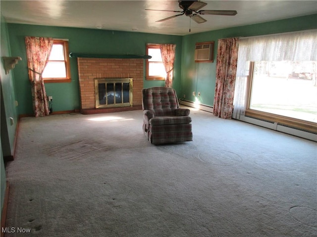 living area featuring a baseboard heating unit, a ceiling fan, a wealth of natural light, and a wall mounted AC