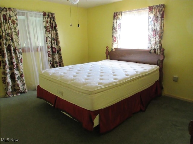 bedroom featuring baseboards and carpet