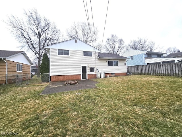 back of property featuring a lawn, a patio, and a fenced backyard