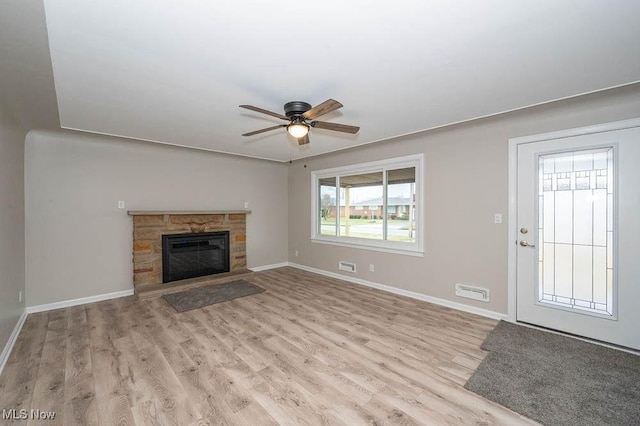 unfurnished living room featuring wood finished floors, baseboards, and ceiling fan