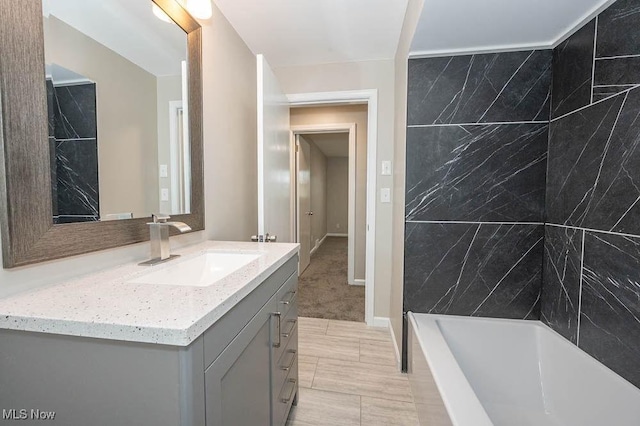 full bathroom featuring vanity and baseboards