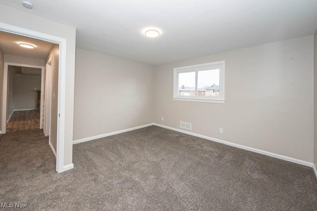 unfurnished bedroom with carpet flooring, baseboards, and visible vents