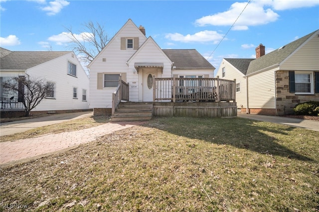 bungalow featuring a wooden deck and a front yard