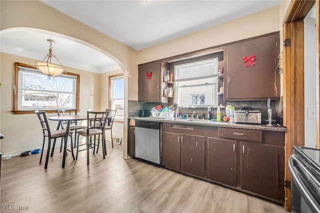 kitchen featuring backsplash, dark brown cabinetry, light wood-style flooring, stainless steel dishwasher, and open shelves