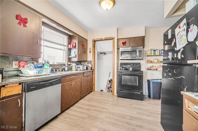 kitchen with black appliances, light wood-style flooring, open shelves, and a sink