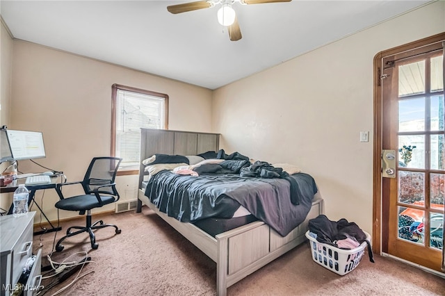 bedroom with visible vents, a ceiling fan, and carpet floors