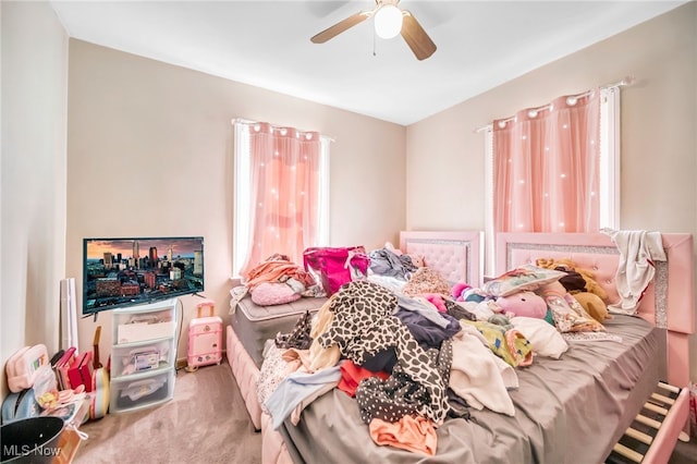 bedroom featuring ceiling fan and carpet