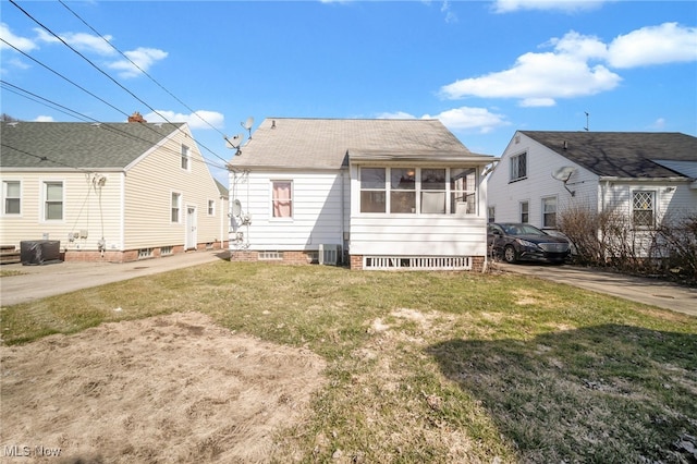 rear view of property featuring a yard