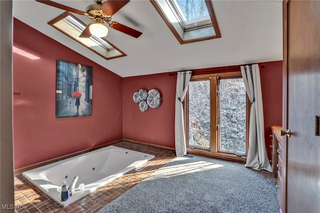 1580 Salway Ave SW, North Canton, OH 44709 - bathroom with lofted ceiling with skylight, a jetted tub, and a ceiling fan