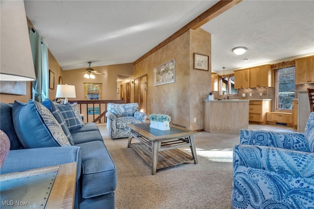 1580 Salway Ave SW, North Canton, OH 44709 - living room with ceiling fan, lofted ceiling with beams, baseboards, and light carpet