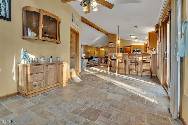 1580 Salway Ave SW, North Canton, OH 44709 - interior space featuring stone tile floors, vaulted ceiling with beams, baseboards, and ceiling fan