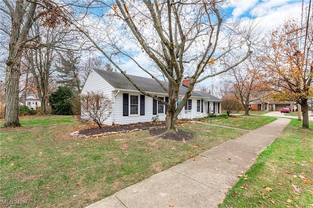 single story home with a chimney and a front lawn