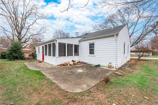 exterior space with a yard, a sunroom, and a patio area