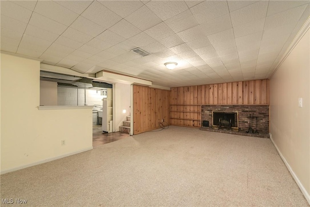 unfurnished living room featuring visible vents, a brick fireplace, baseboards, carpet, and stairs